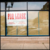 store window with lease sign in window