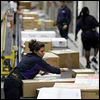 Fed Ex workers shipping packages